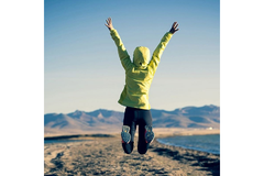 Woman happy and active jumping in nature
